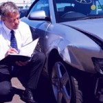 Man inspects car paint damage